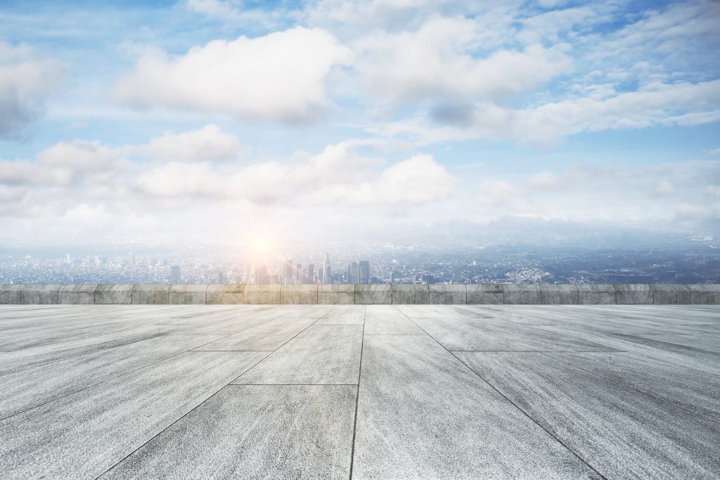 Concrete floor with a view of a city in the distance